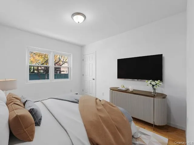 a bedroom with a bed and a flat screen tv