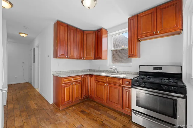 a kitchen with stainless steel appliances granite countertop a stove a sink and a microwave