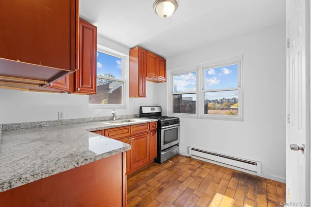 a kitchen with granite countertop a sink and a stove top oven