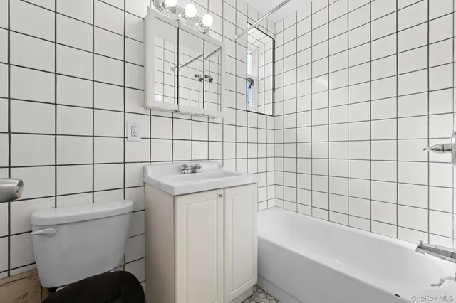 a bathroom with a bathtub and toilet