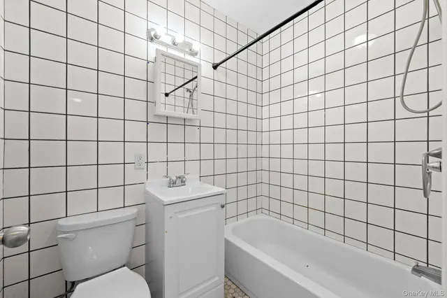 a bathroom with a bathtub and toilet