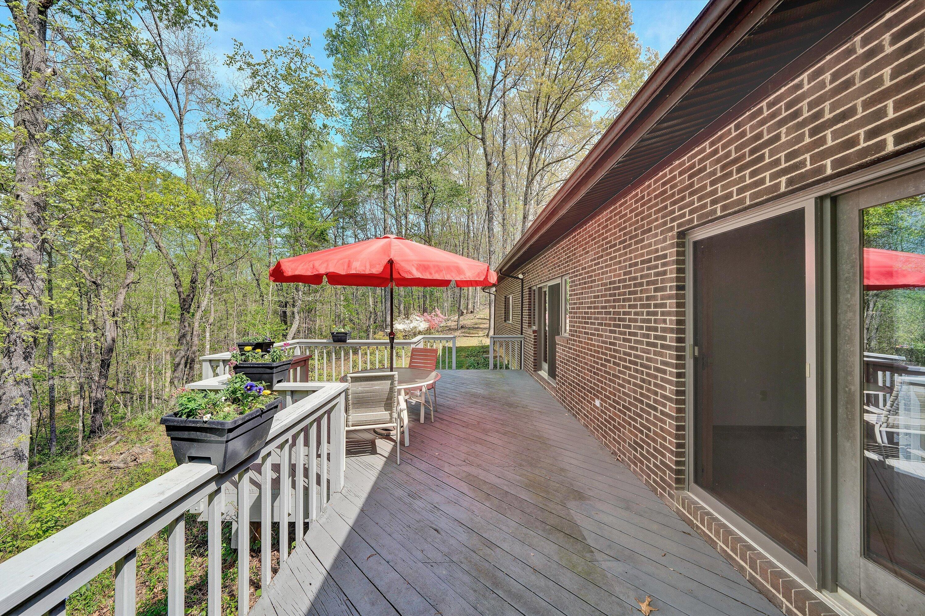 1124 Old Hollow Road Buchanan, VA 24066 - Photo 38 of 73 a view of a balcony with chairs and wooden floor