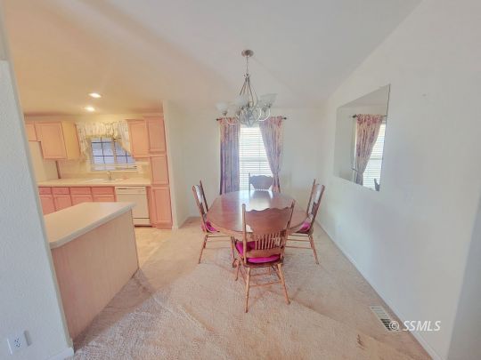 747 North Charles Street Ridgecrest, CA 93555 - Photo 4 of 23 a living room with furniture a window and a dining table