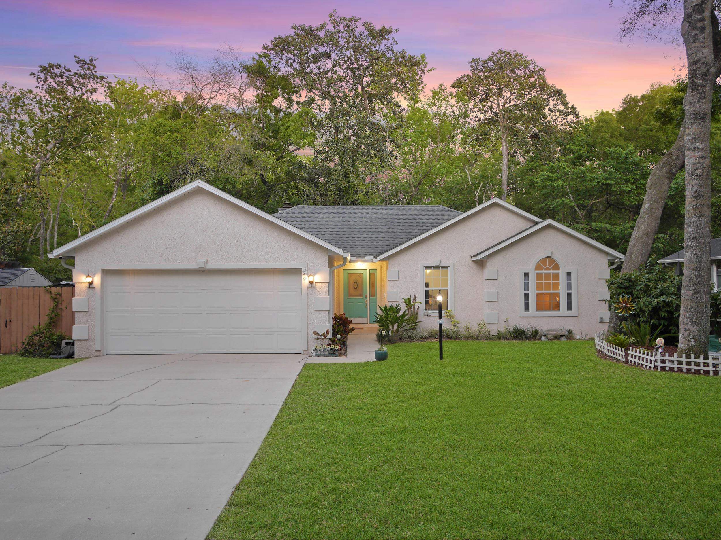 a front view of house with yard and green space
