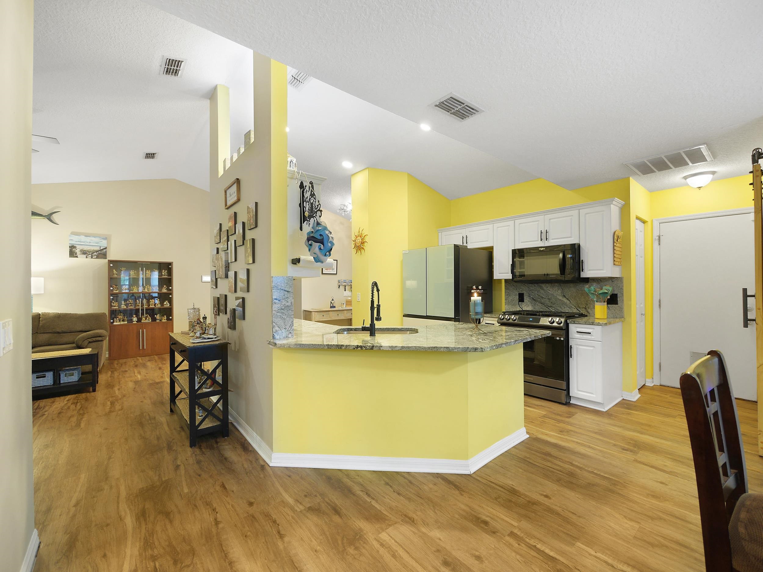 549 Willow Walk Place St. Augustine, FL 32086 - Photo 12 of 32 a view of a kitchen with kitchen island a counter top space a sink stainless steel appliances and cabinets