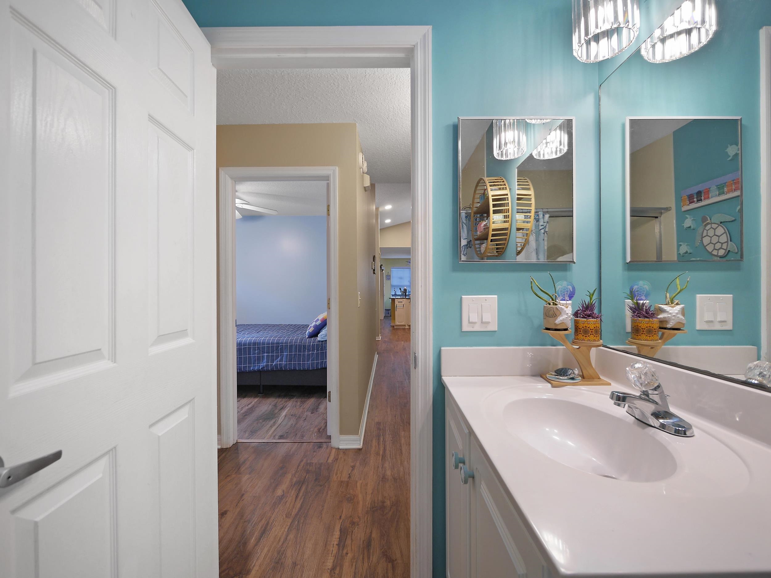 549 Willow Walk Place St. Augustine, FL 32086 - Photo 19 of 32 a en suite bathroom with a sink a mirror and a shower