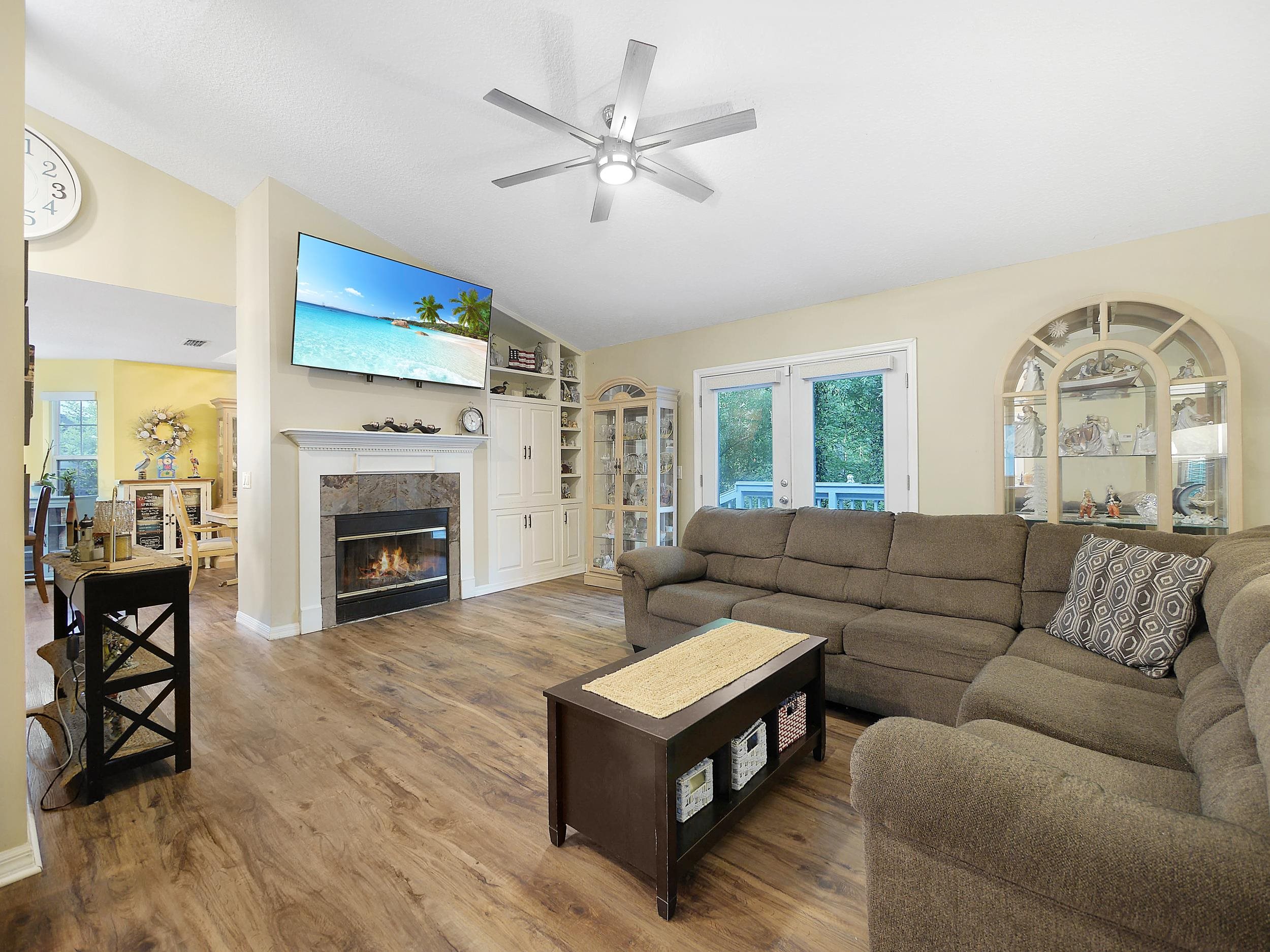 549 Willow Walk Place St. Augustine, FL 32086 - Photo 4 of 32 a living room with furniture a fireplace and a flat screen tv