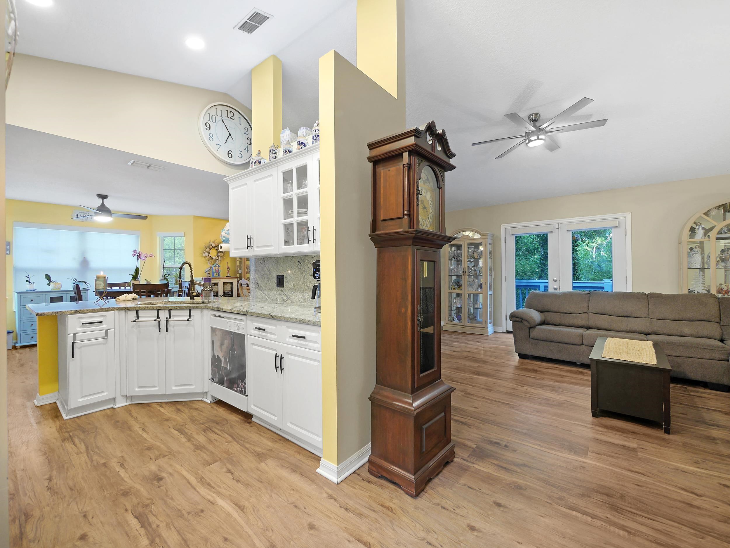 549 Willow Walk Place St. Augustine, FL 32086 - Photo 5 of 32 a open kitchen with stainless steel appliances granite countertop a refrigerator and a stove top oven