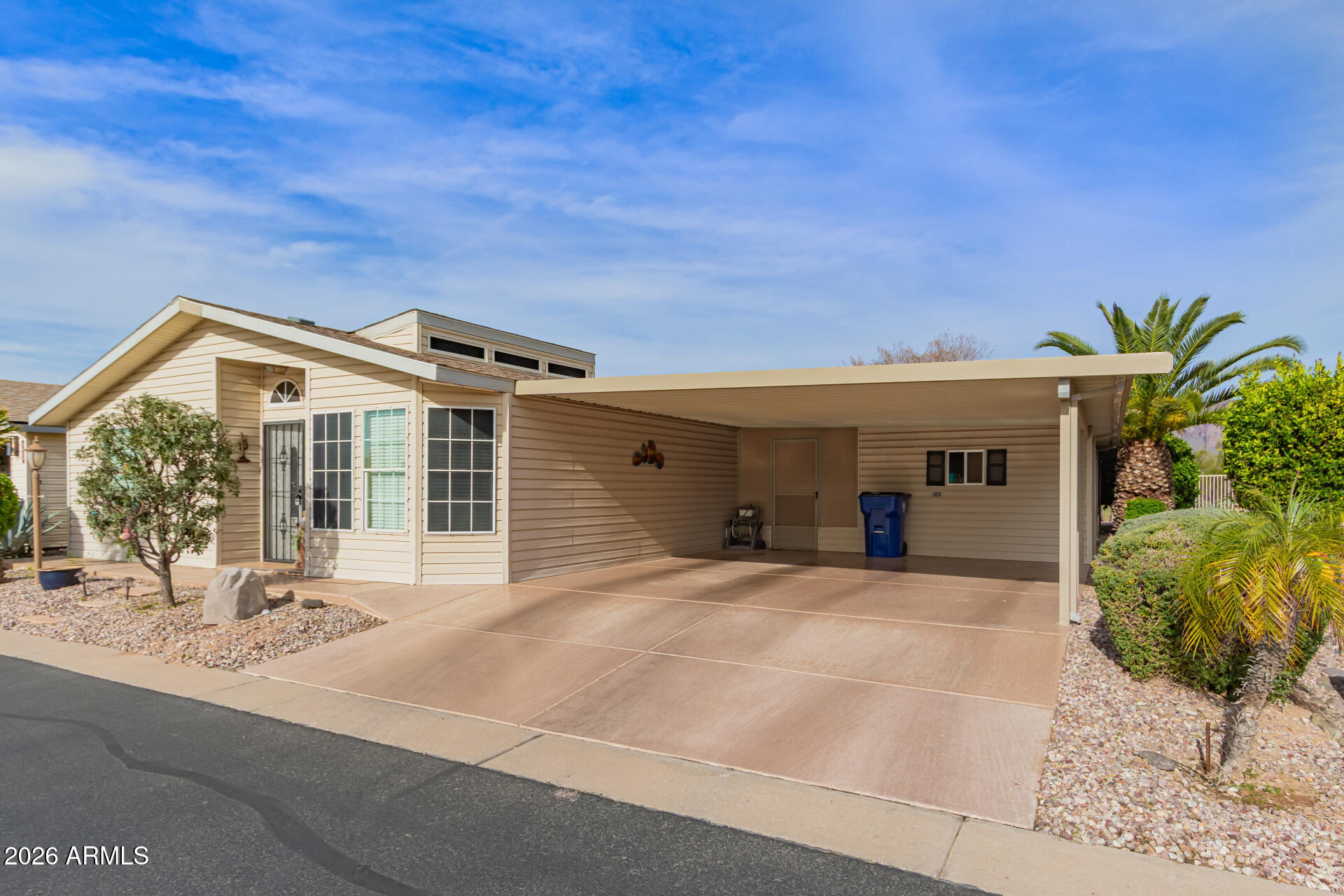 3301 South Goldfield Road, Unit 4028 Apache Junction, AZ 85119 - Photo 15 of 43 a front view of a house with a yard and garage