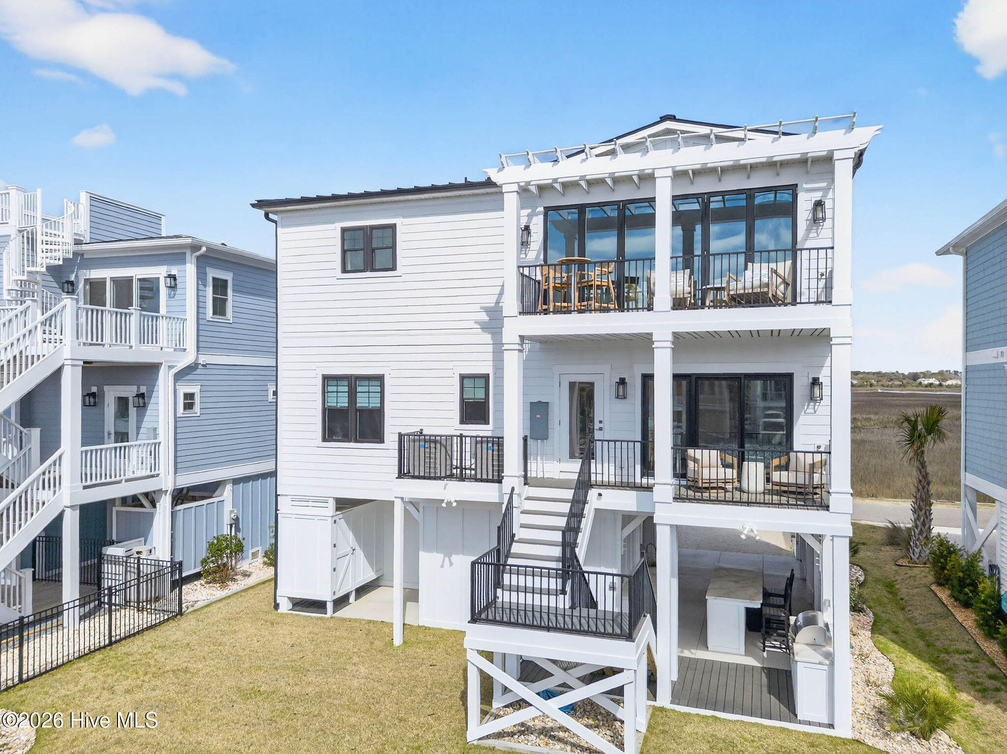 1416 Riverside Drive Sunset Beach, NC 28468 - Photo 66 of 83 Full rear view of waterfront property with decks, dock, and access to the Intracoastal Waterway.