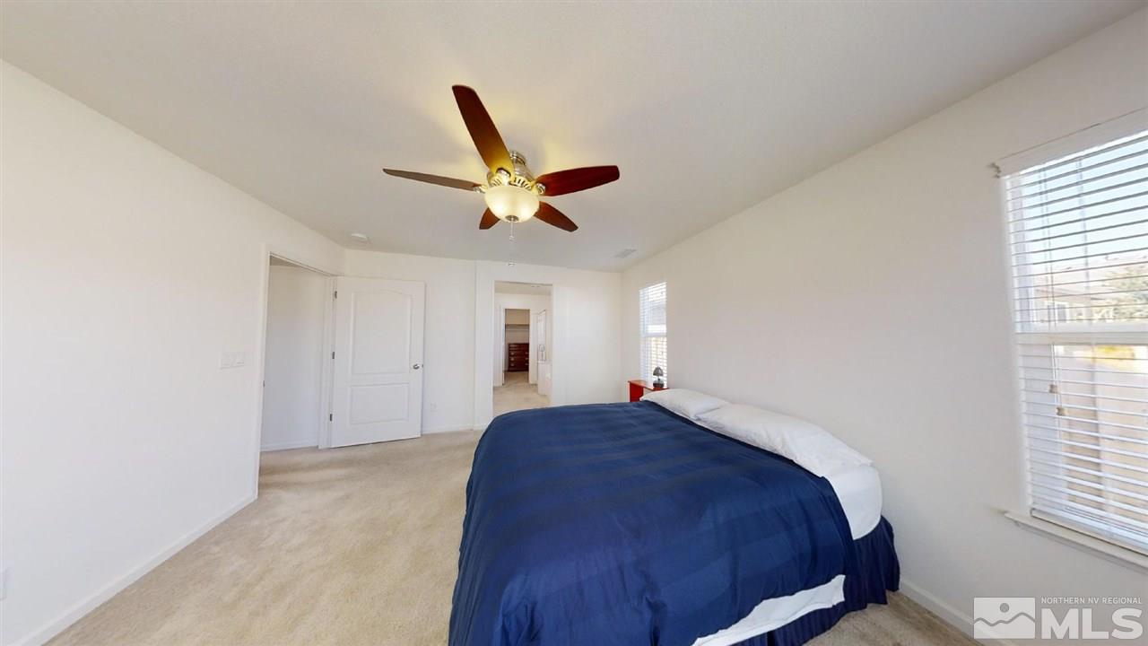 335 Teramo Drive Reno, NV 89521 - Photo 11 of 21 a bedroom with a bed and a large window