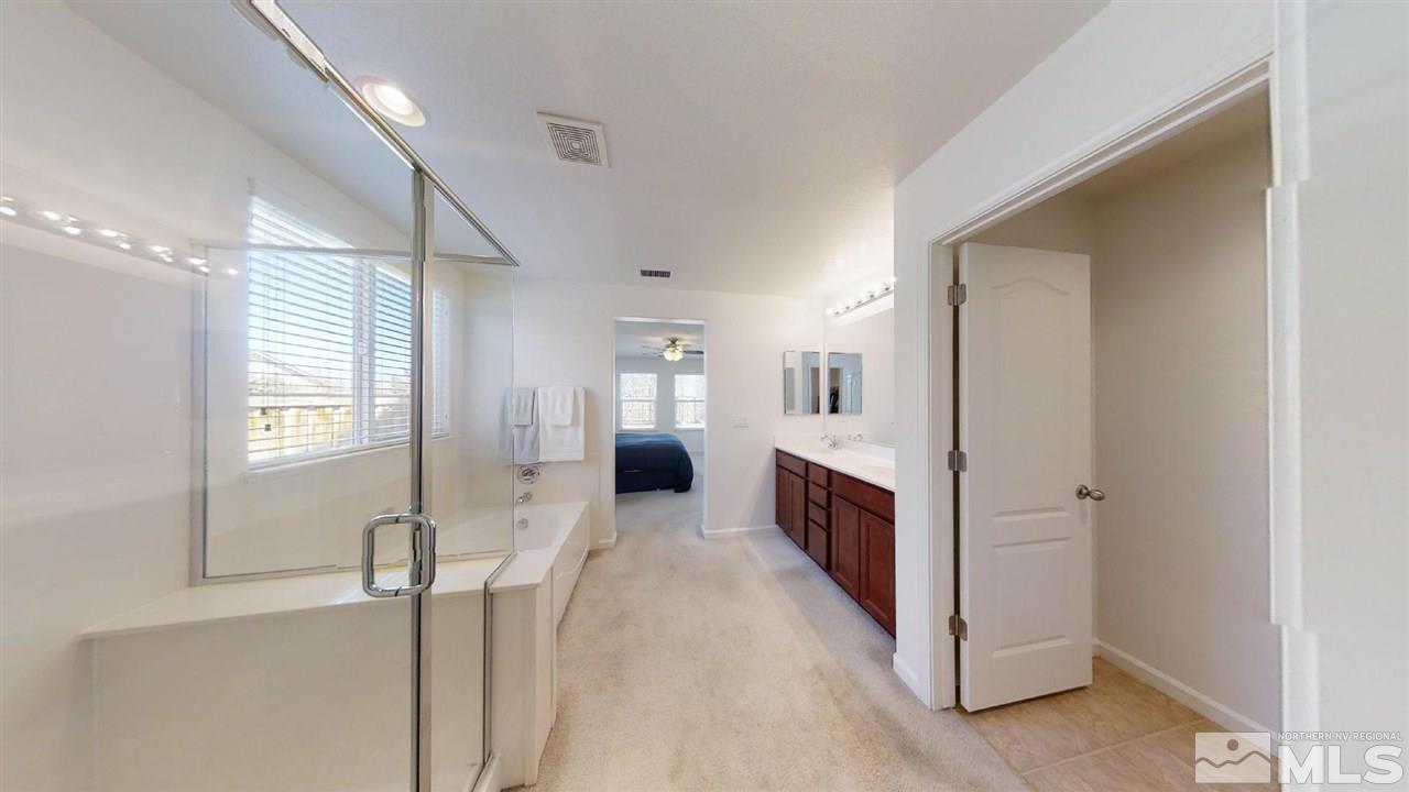 335 Teramo Drive Reno, NV 89521 - Photo 14 of 21 a large white kitchen with stainless steel appliances granite countertop a refrigerator and a stove top oven