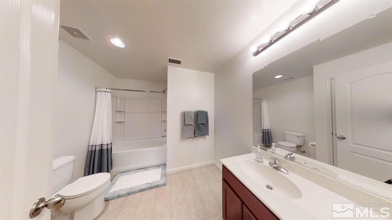 335 Teramo Drive Reno, NV 89521 - Photo 15 of 21 a bathroom with a sink mirror vanity and toilet