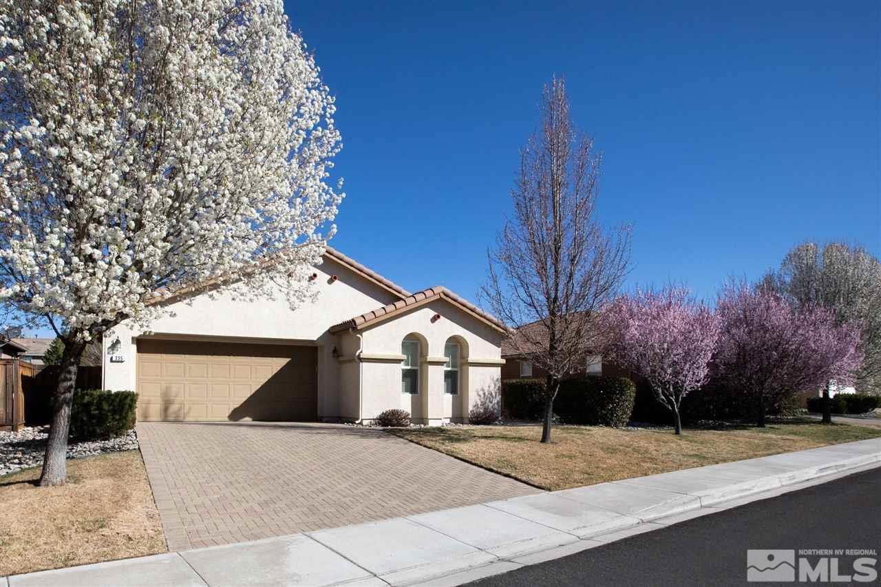 335 Teramo Drive Reno, NV 89521 - Photo 2 of 21 a view of a white house with a large tree