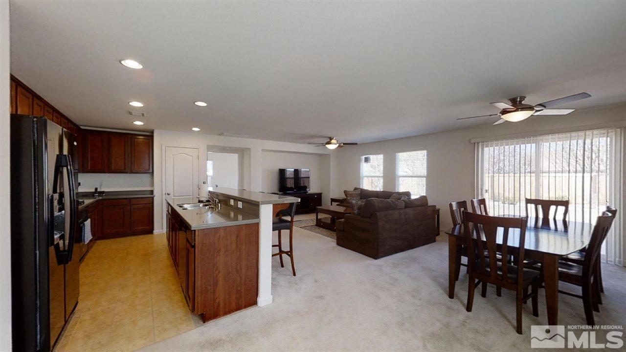 335 Teramo Drive Reno, NV 89521 - Photo 3 of 21 a living room with furniture a dining table and a large window