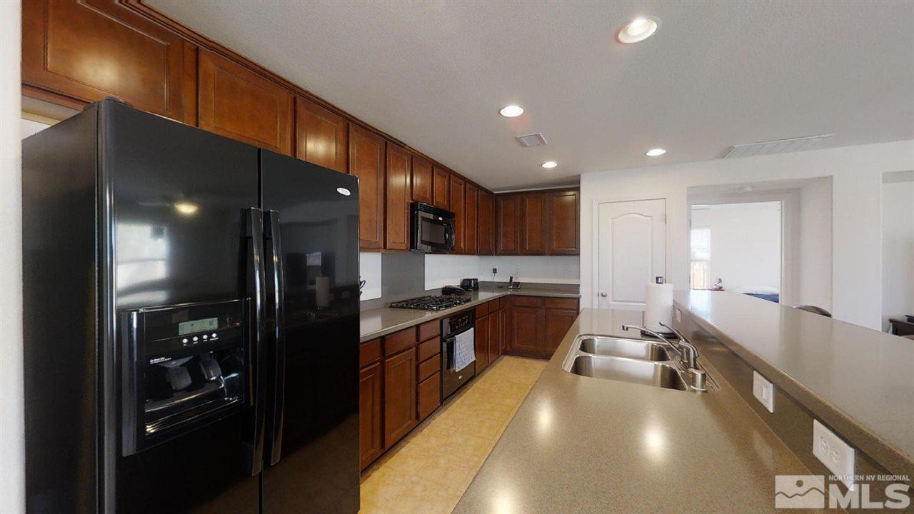 335 Teramo Drive Reno, NV 89521 - Photo 4 of 21 a large kitchen with lots of counter top space and stainless steel appliances