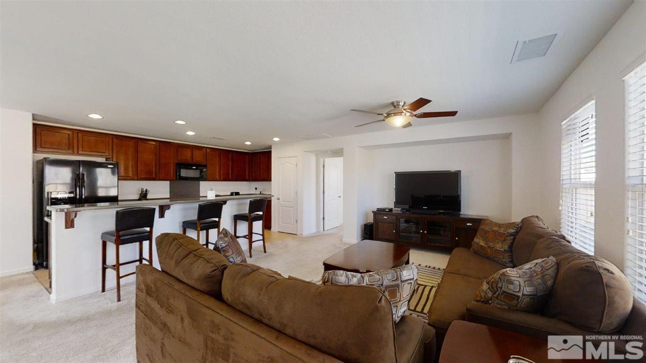 335 Teramo Drive Reno, NV 89521 - Photo 6 of 21 a living room with furniture and a flat screen tv