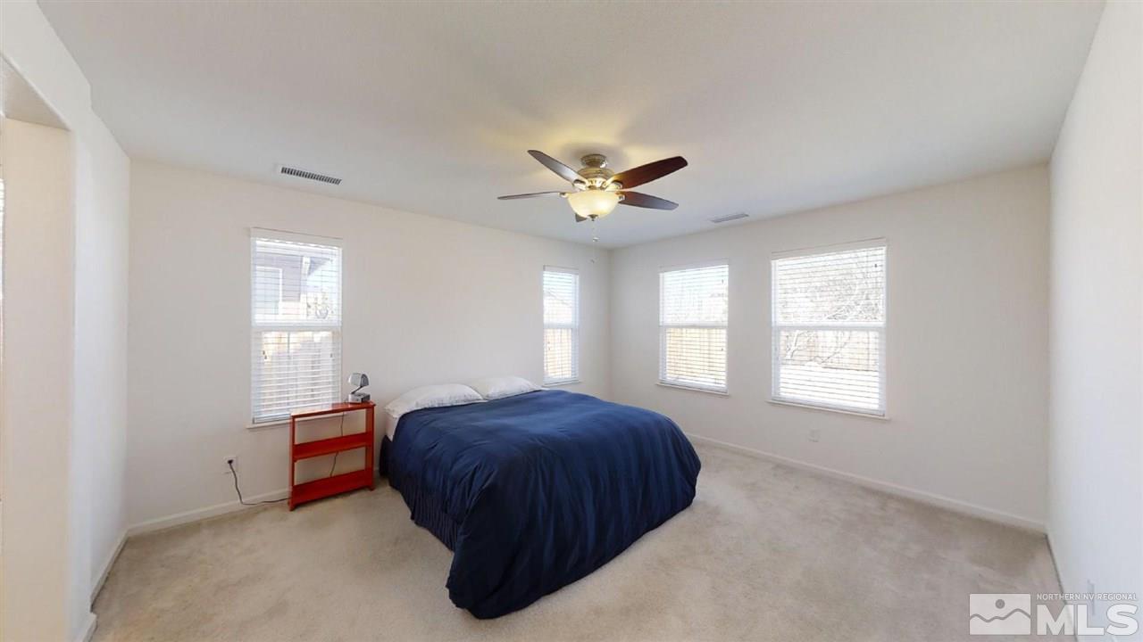 335 Teramo Drive Reno, NV 89521 - Photo 10 of 21 a bed room with a bed and a ceiling fan