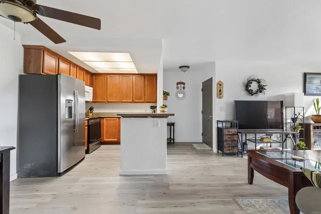 a kitchen with stainless steel appliances a refrigerator and a stove top oven