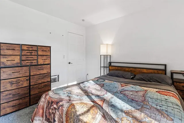 a bedroom with a bed and with view of closet