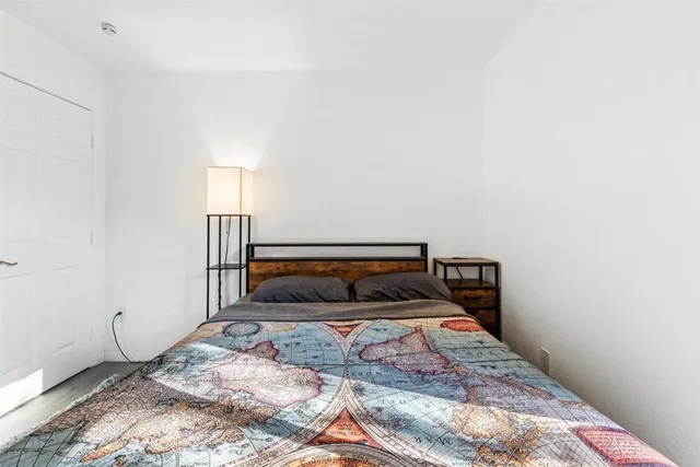 a bedroom with a bed and a window