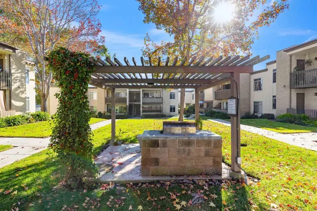 a view of a house with a wooden fence