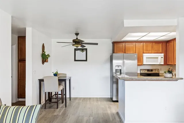 a kitchen with stainless steel appliances a sink a stove and a refrigerator