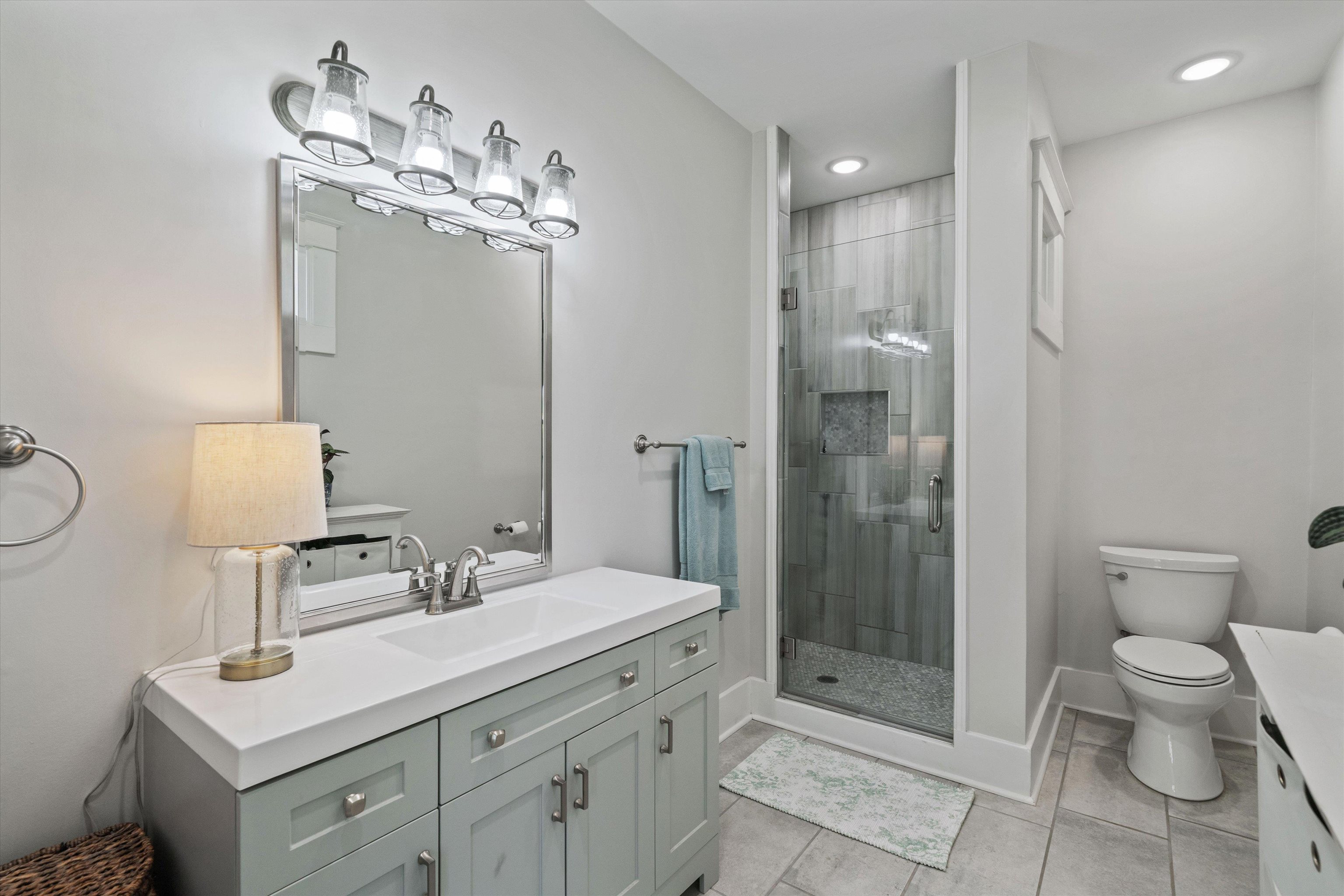 1893 Felix Avenue Memphis, TN 38114 - Photo 14 of 25 a bathroom with a toilet a sink and glass door