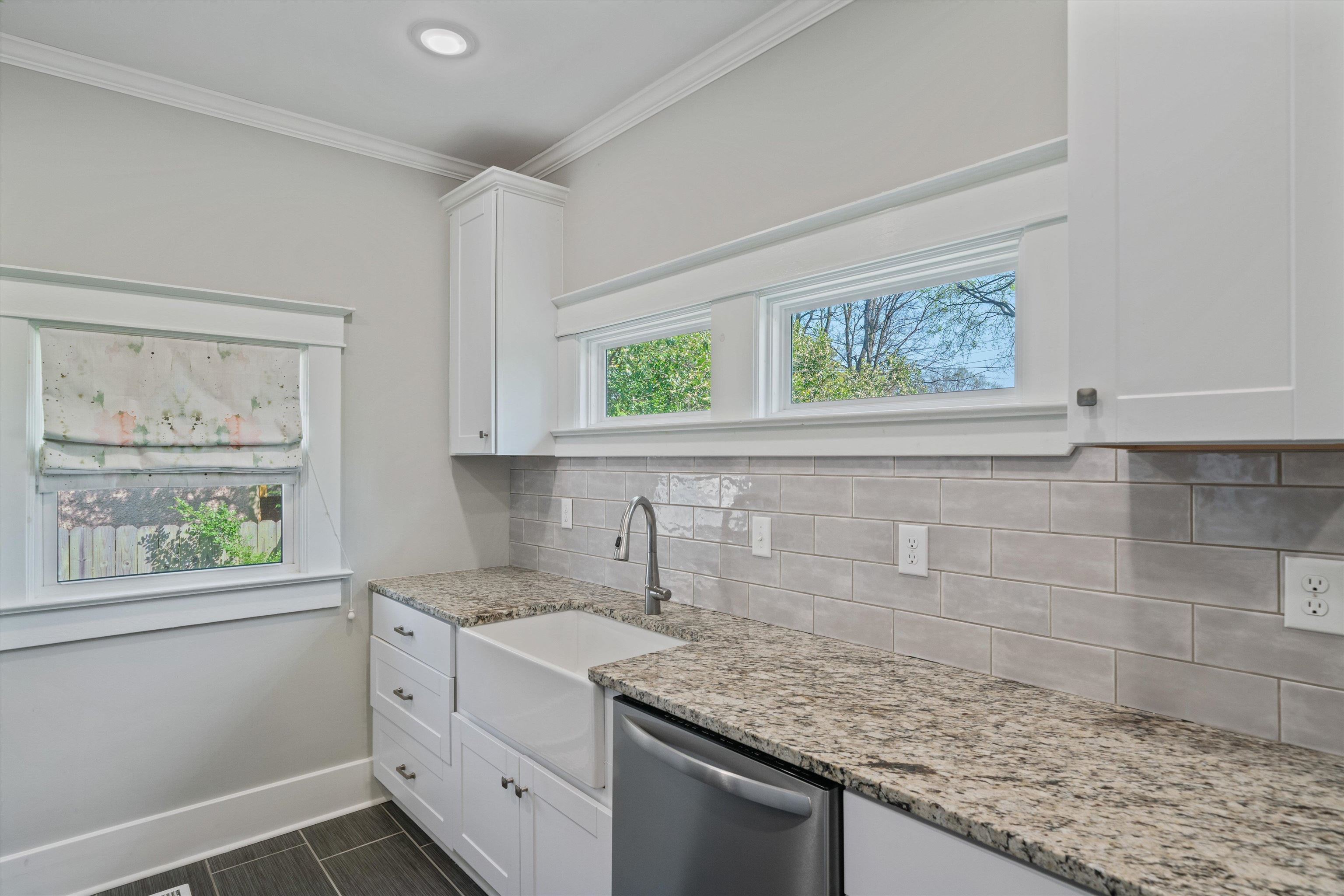 1893 Felix Avenue Memphis, TN 38114 - Photo 10 of 25 a kitchen with a granite countertop sink a window and cabinets