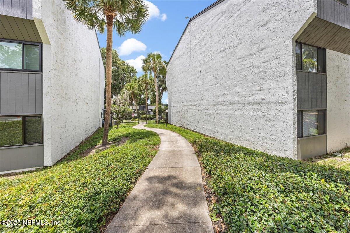 2628 Southwest 14th Drive, Unit 326 Gainesville, FL 32608 - Photo 12 of 17 a view of a pathway with flower garden