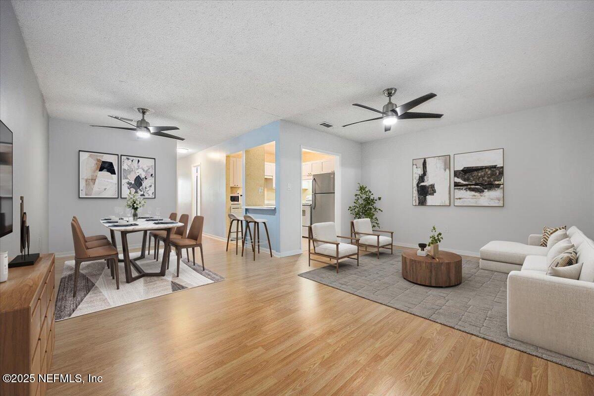 2628 Southwest 14th Drive, Unit 326 Gainesville, FL 32608 - Photo 3 of 17 a living room with furniture a window and a table