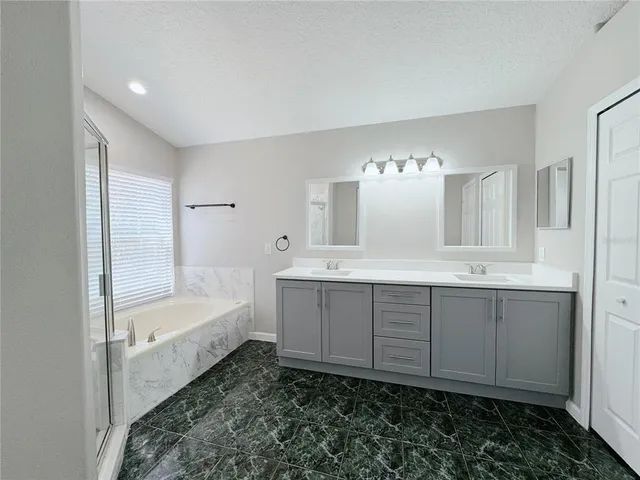 a bathroom with a double vanity sink and mirror