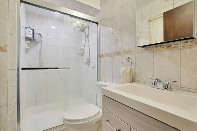 a bathroom with a sink a mirror and a shower