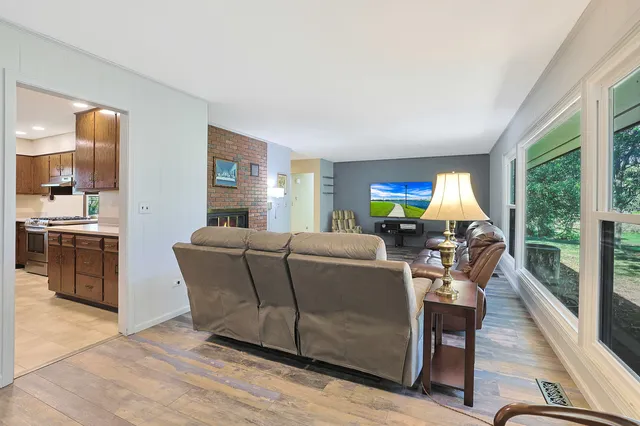 a living room with furniture and a open kitchen view