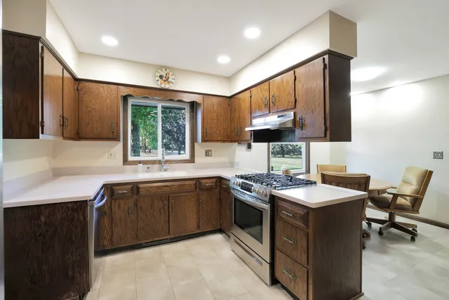 a kitchen with a sink stove and microwave