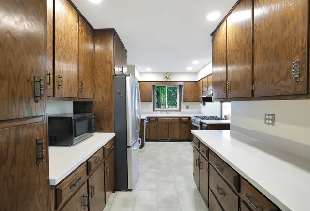 a kitchen with counter top space cabinets and stainless steel appliances