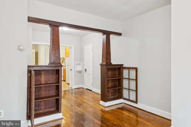 a view of a room with wooden floor and cabinet