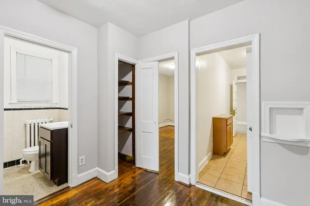 a view of walk in closet with wooden floor