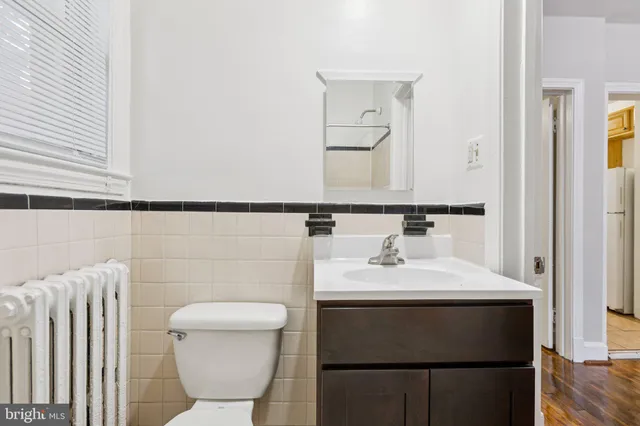 a view of room with wooden floor and bathroom