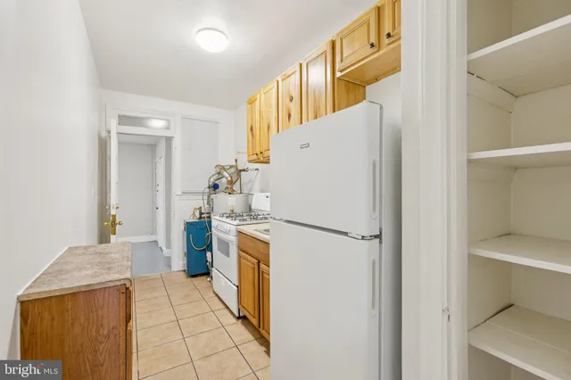 a kitchen with a stove and a refrigerator