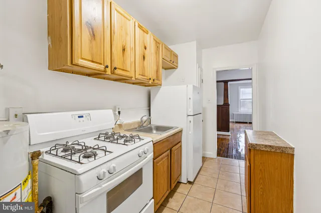 a kitchen with a stove and a refrigerator
