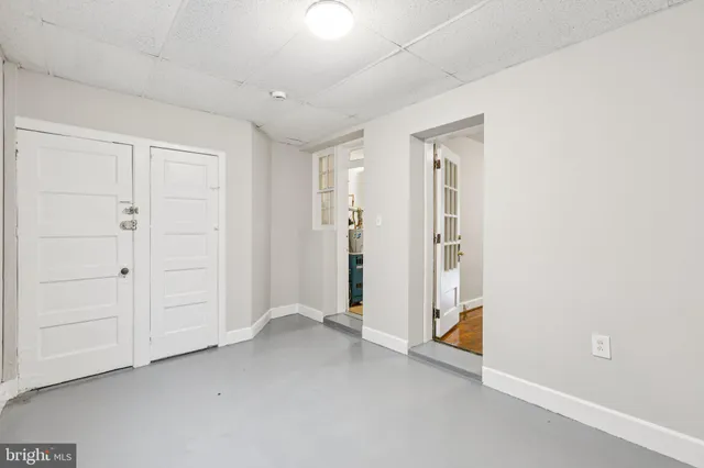 an empty room with windows and closet