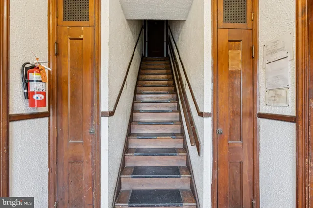 a view of a hallway with wooden floor and entryway