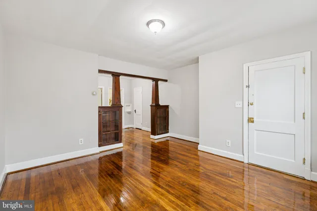 wooden floor in an empty room with a window