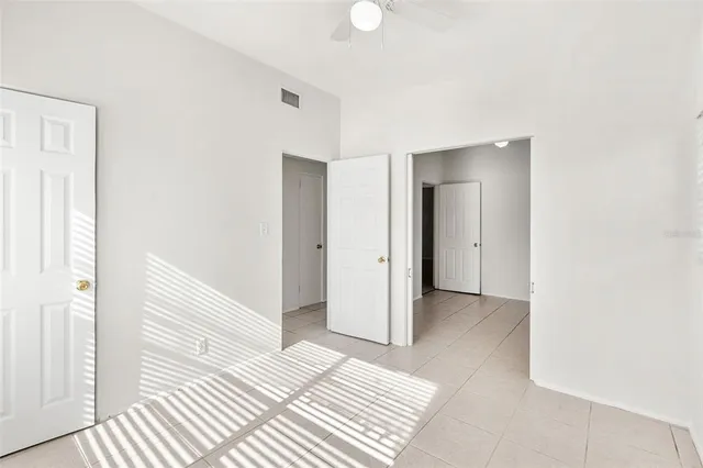 a view of a bedroom with a bed and a hallway