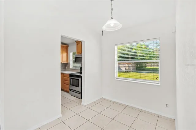 a view of an empty room with window and cabinet