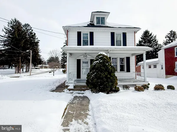 a view of a house with snow on the background