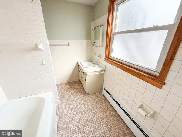 a bathroom with a bathtub and a toilet