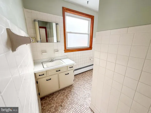 a kitchen with stainless steel appliances granite countertop a sink window and cabinets