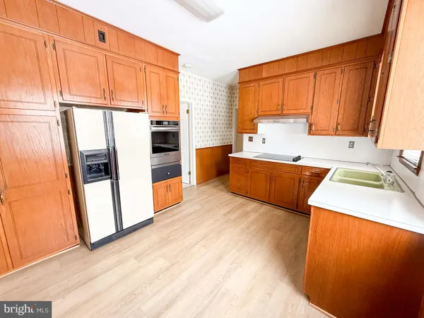 a large white kitchen with a large window